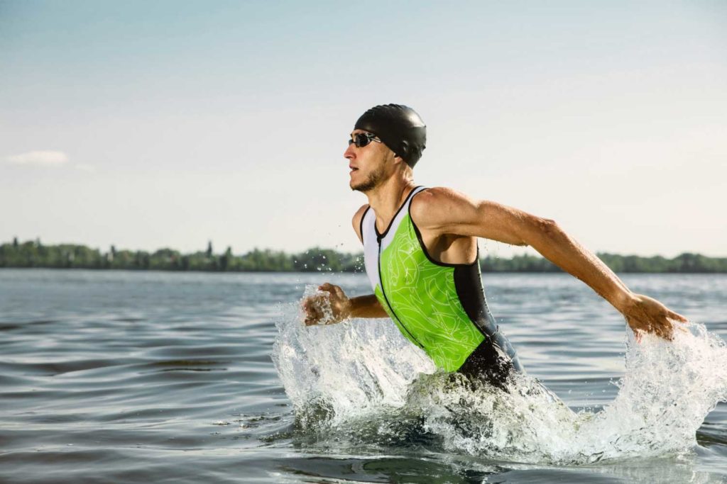 professional triathlete swimming river s open water man wearing swim equipment practicing triathlon beach summer s day concept healthy lifestyle sport action motion movement